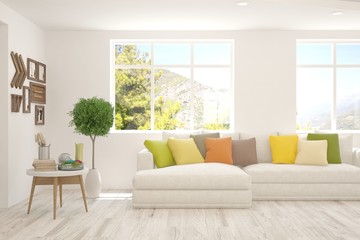 White living room with sofa and summer landscape in window. Scandinavian interior design. 3D illustration