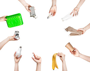 A lot of woman's hands are holding different kind of garbage