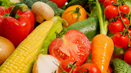 Closeup abstract image of fresh cut vegetables on kitchen table Background for healthy food and GMO free products.Diet nutrition and fresh vegetables. Vegan and vegetarian background.