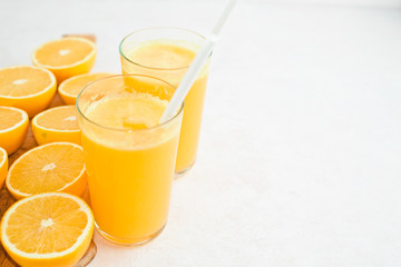 Orange juice in glass, fresh fruits on wooden background