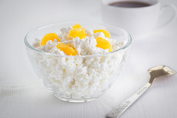 Cottage cheese in a plate isolated on a light background.