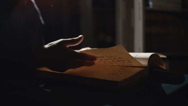 Monk is reading an old book in dark