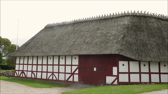 Holm, Denmark - May 27, 2019: Thatched half timbered building on cobbled street in old Southern Danish village