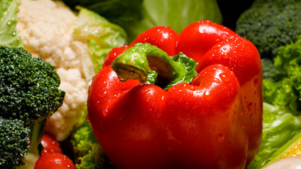 Closeup photo of water dropelts on red bell pepper on kitchen desk. Background for healthy food and GMO free products.Diet nutrition and fresh vegetables. Vegan and vegetarian background.