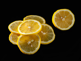  Slices of lemon over black background