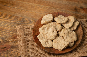 Raw Dehydrated Soy Meat or Soya Chunks on Wood Background