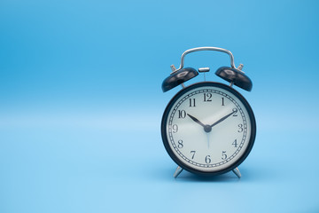 Alarm clock on blue background with copy space for you design.