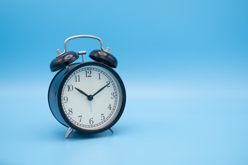 Alarm clock on blue background with copy space for you design.