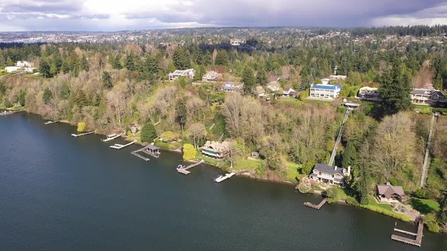 Aerial / drone footage of Lake Washington waterfront mansions, luxury homes and villas in Medina near Belleview and Seattle, Washington during the COVID-19 pandemic