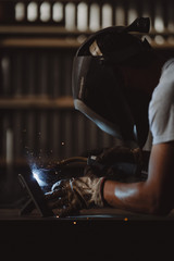 Professional welder at work in his factory