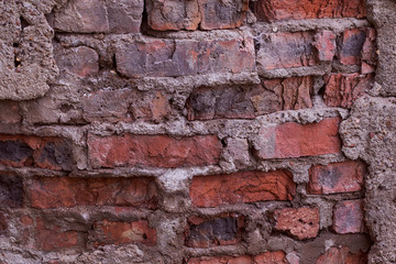 old brick of red clay old cement masonry close-up