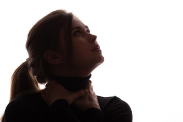 portrait face of young beautiful woman in a black with hands clutching neck looking up hopefully, epidemic smothers a person, concept life and death