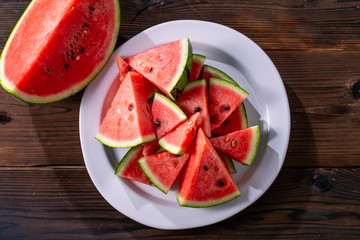 Sliced watermelon on wooden background.