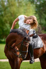 Obraz premium Beautiful young girl rider and her horse