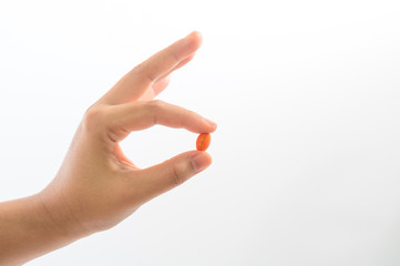 Pick up vitamin capsules to eat
