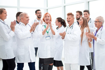 Fototapeta na wymiar group of diverse smiling doctors applauding together.