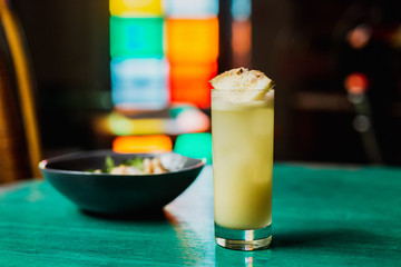 A long iced drink garnished with pineapple