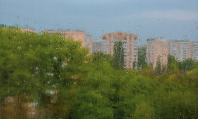 Rainy day in the city-drops on the window, view from the window on the city