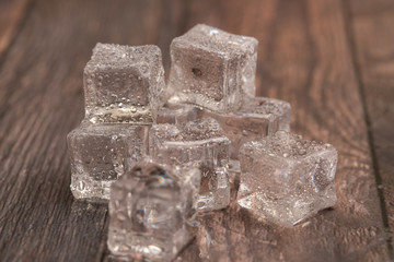 Ice cubes on a wooden background