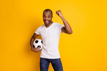 Yeah we win. Positive ecstatic afro american football fan guy hold soccer ball support national...