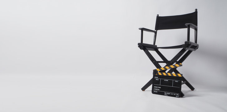 Director chair with black and yellow clapper board or movie slate on white background.it is used in video production and film industry.