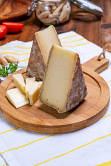 Cheese tomme de montagne or tomme de savoie made from cow milk in French Alps.