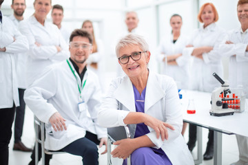 research supervisor and a group of young scientists in the workplace .