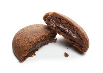 Round chocolate cake, pastry with creamy filling sliced in half isolated on white background