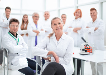 Fototapeta premium research supervisor and a group of young scientists in the workplace .