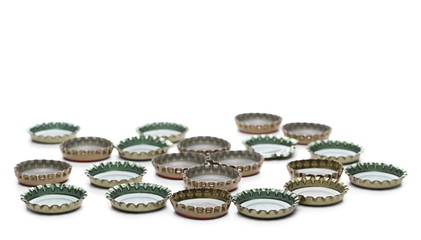 Bottle caps pile isolated on white background
