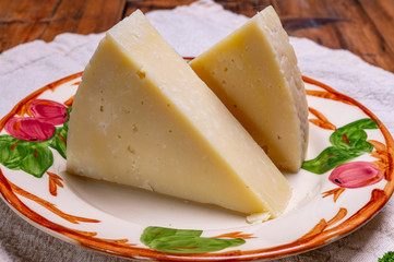 Pieces of matured pecorino romano italian cheese made from sheep milk in Lazio, Sardinia or Tuscany