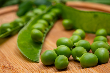 New harvest of ripe green peas legumes