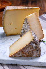Cheese tomme de montagne or tomme de savoie made from cow milk in French Alps.