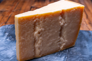 Big wedge of parmigiano-reggiano parmesan hard Italian cheese made from cow milk or Grana Padano