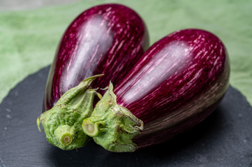 Fresh uncooked graffiti or Sicilian eggplants vegetables with purple and white stripes.