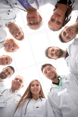 Fototapeta na wymiar close up. group of doctors standing in a circle and looking at you