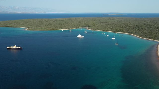 People in boats enjoying the beautiful blue waters of the Olib Island in Croatia - aerial