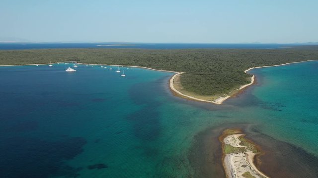 The beautiful calm waters of Olib Island in Croatia with boats by the beach - aerial