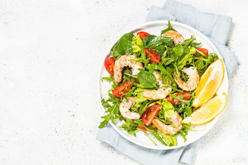 Shrimp salad with vegetables and leaves.