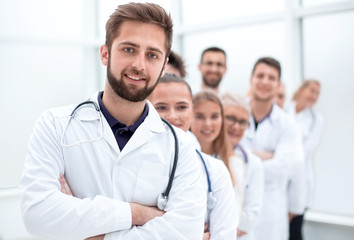 Fototapeta premium close up. confident male doctor standing in front of his colleagues.