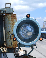 A signal lamp is on the navy ship for optical communication.