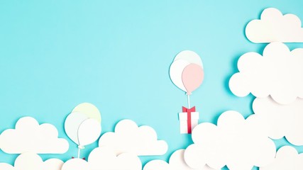 Papercut balloons and Gift Box floating in blue sky with clouds. Happy Bithday, Merry Christmas festive poster. Greeting card with paper craft - Powered by Adobe