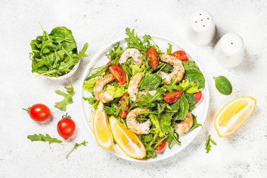 Shrimp salad with vegetables and leaves.
