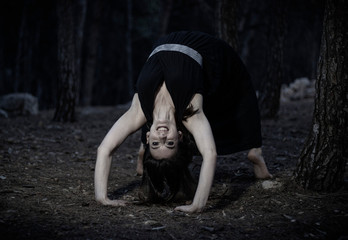 young girl doing the inverted bridge like in the exorcist movie