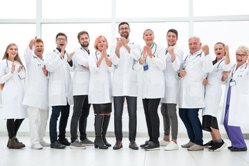 Fototapeta na wymiar tight-knit group of medical center doctors applauding together.