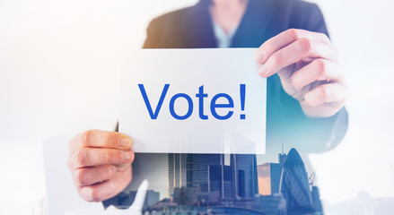 Double exposure of businesswoman in suit holding blank paper for text.