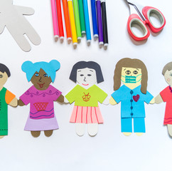 Celebration of bringing people together from all over the world Child makes a paper craft hands. Rainbow Flag Day.