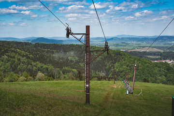 Fototapeta na wymiar Old rust ski lift columns with wire
