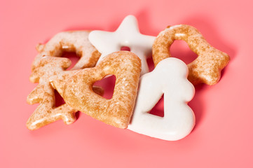 Heap of various festive christmas cookie on pink background. New year celebration concept