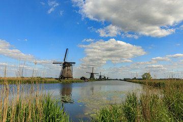 Fototapeta premium Old windmills on dutch landscape, Kinderdijk is a village in the municipality of Molenlanden, in the province of South Holland, Netherlands